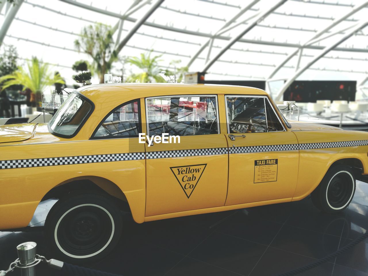 YELLOW VINTAGE CAR ON ROAD