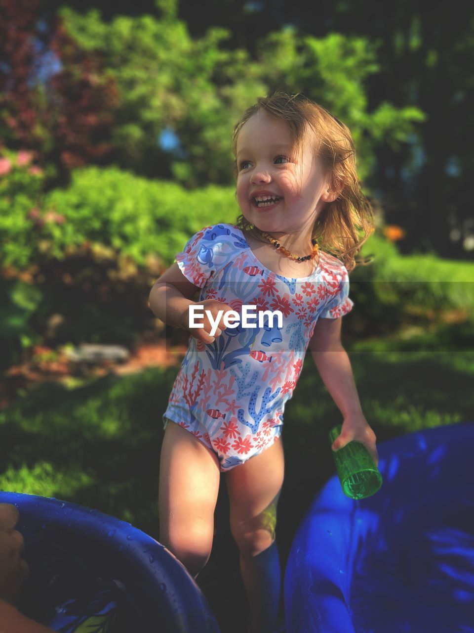 Portrait of cute girl playing in kiddie pool