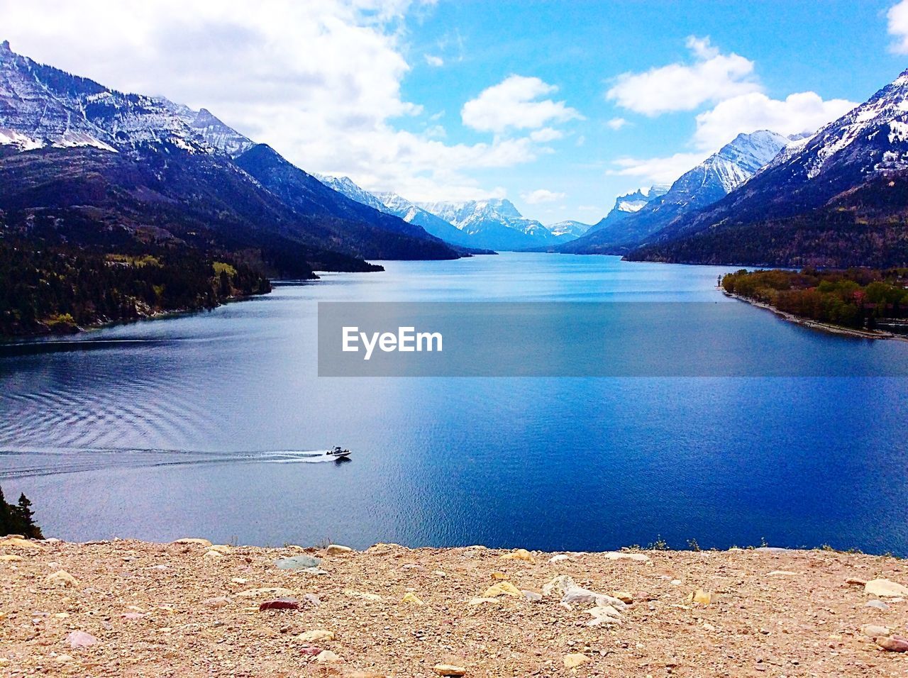 Scenic view of lake against cloudy sky