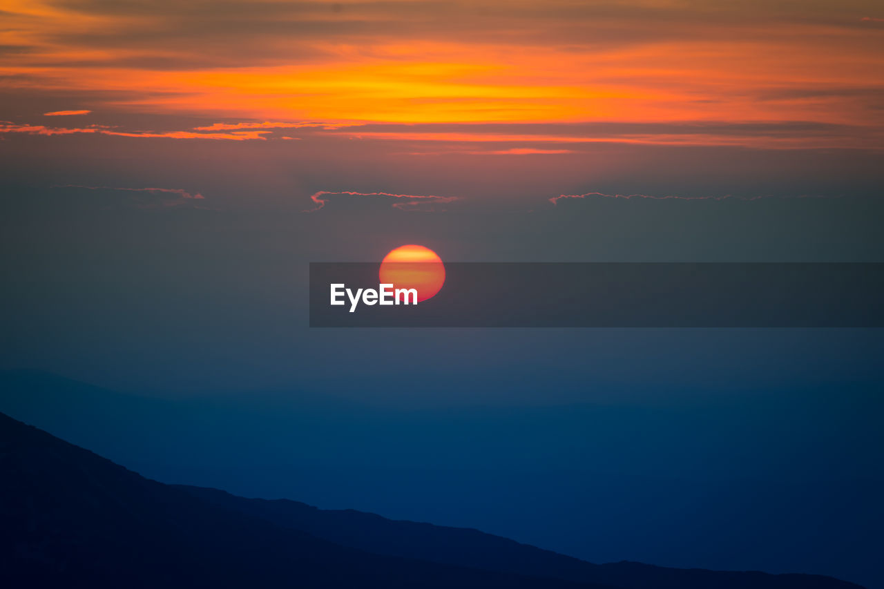 Scenic view of silhouette mountain against sky during sunset