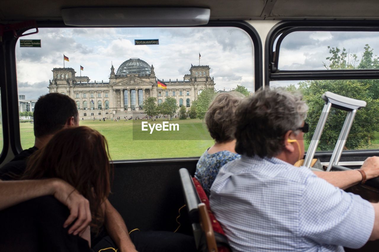 People in bus looking at reichstag building