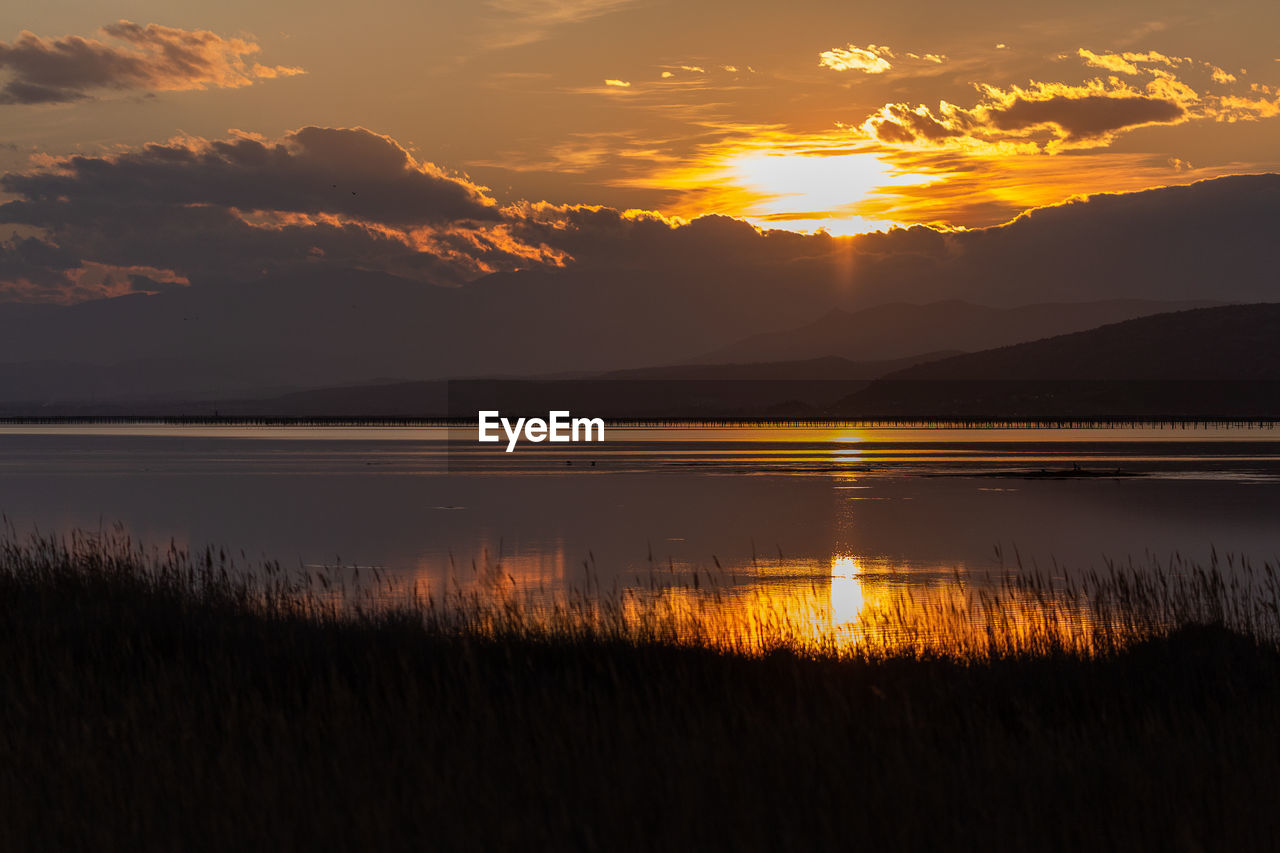 Scenic view of lake against sky during sunset