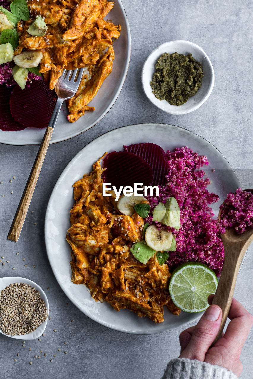 Plates with red quinoa and chicken curry