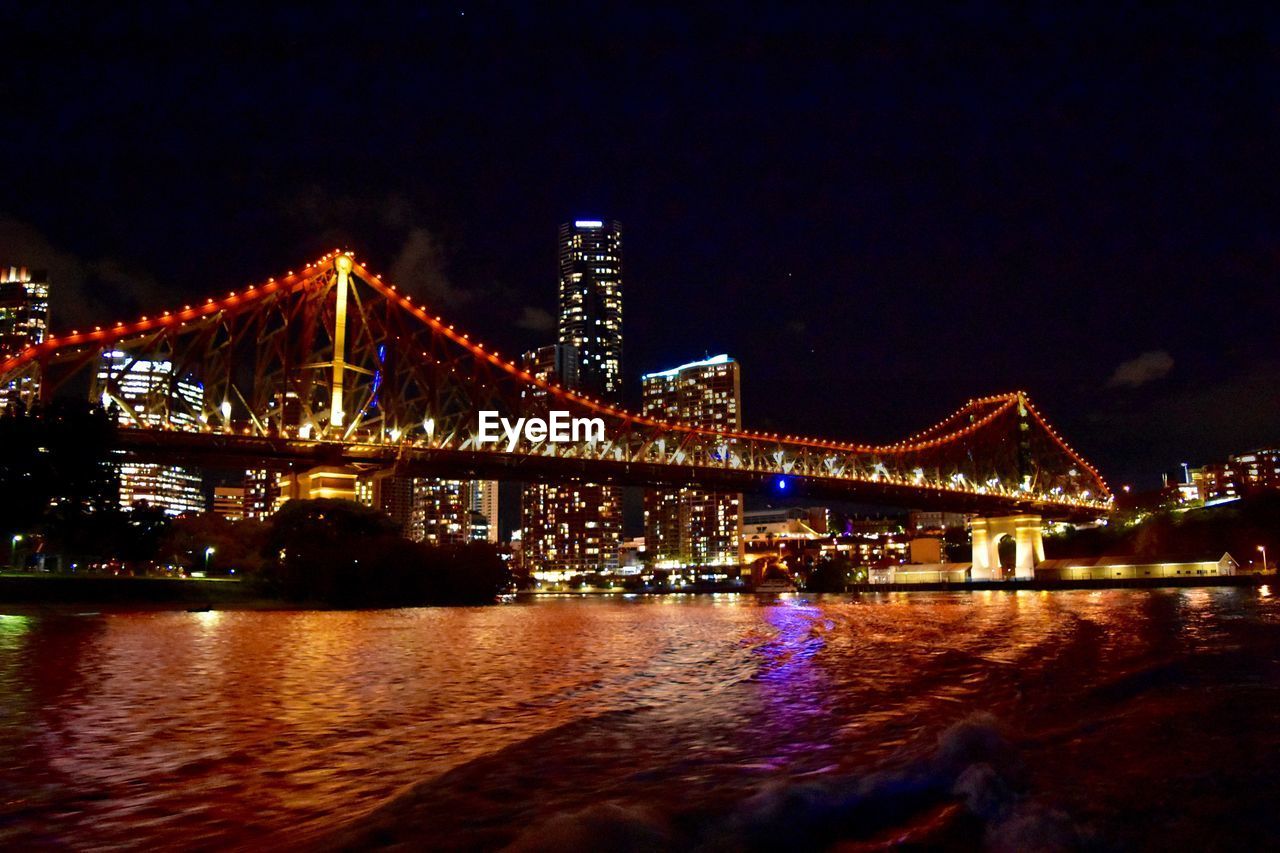 LOW ANGLE VIEW OF ILLUMINATED BRIDGE