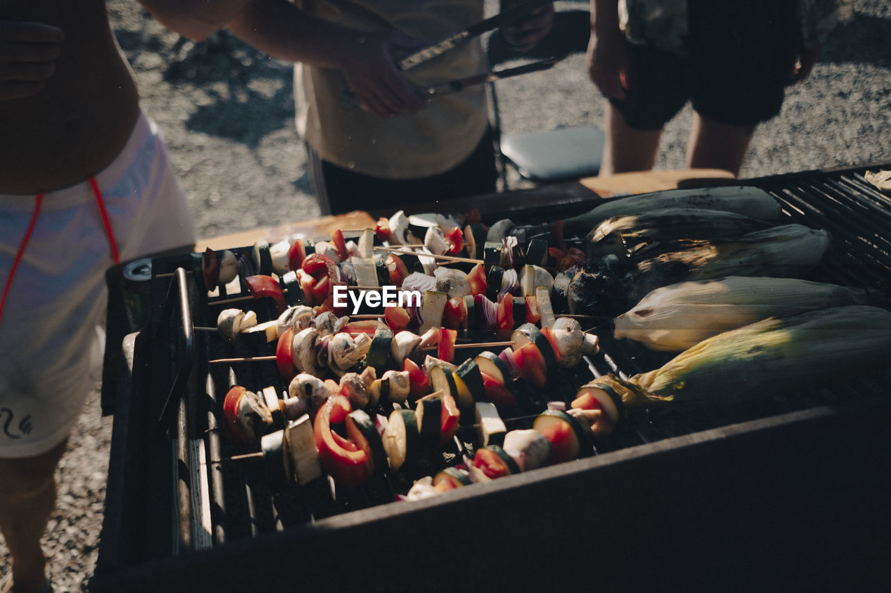 Close up of corn and skewers on a barbecue grill