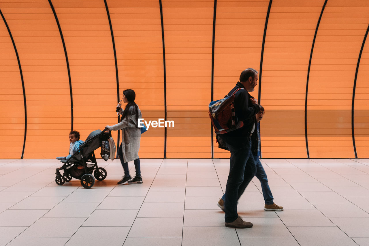 MAN AND WOMAN WALKING ON FLOOR