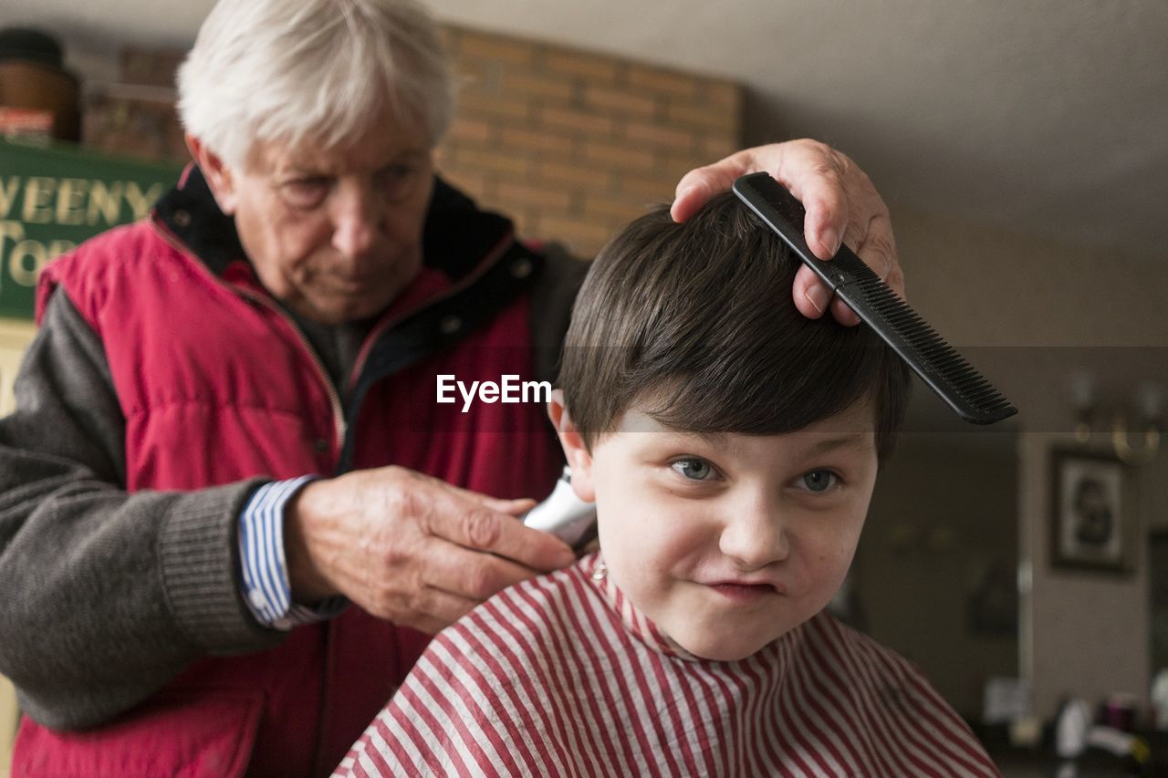 Close-up of a boy getting a haircut at the barber