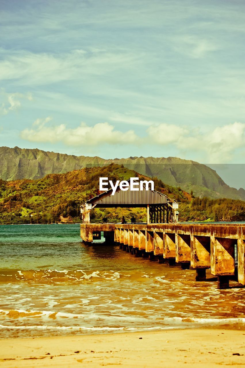 SCENIC VIEW OF LAKE AGAINST MOUNTAIN