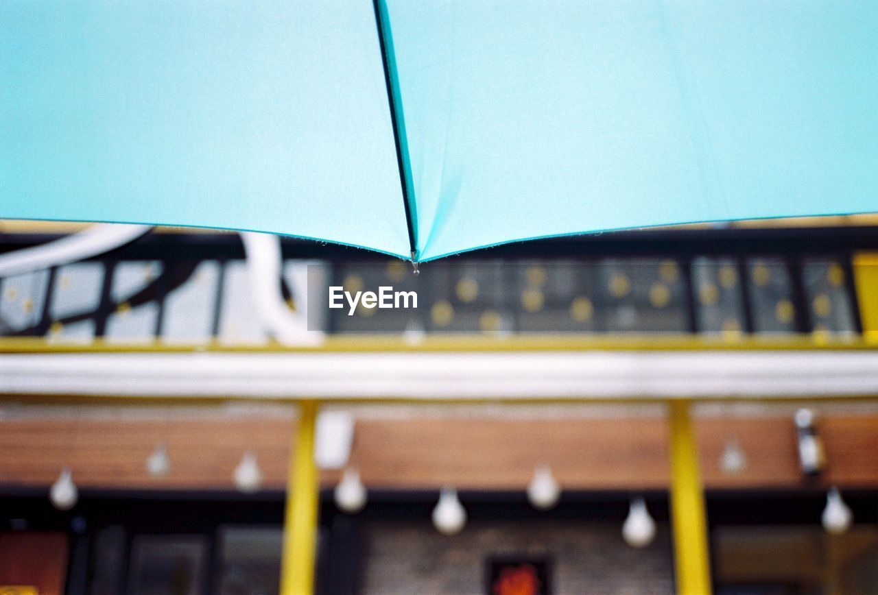 BLUE CAR AGAINST BLURRED MOTION OF BUS