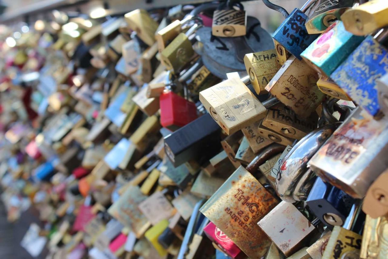 Close-up of love locks on railing at pont des arts