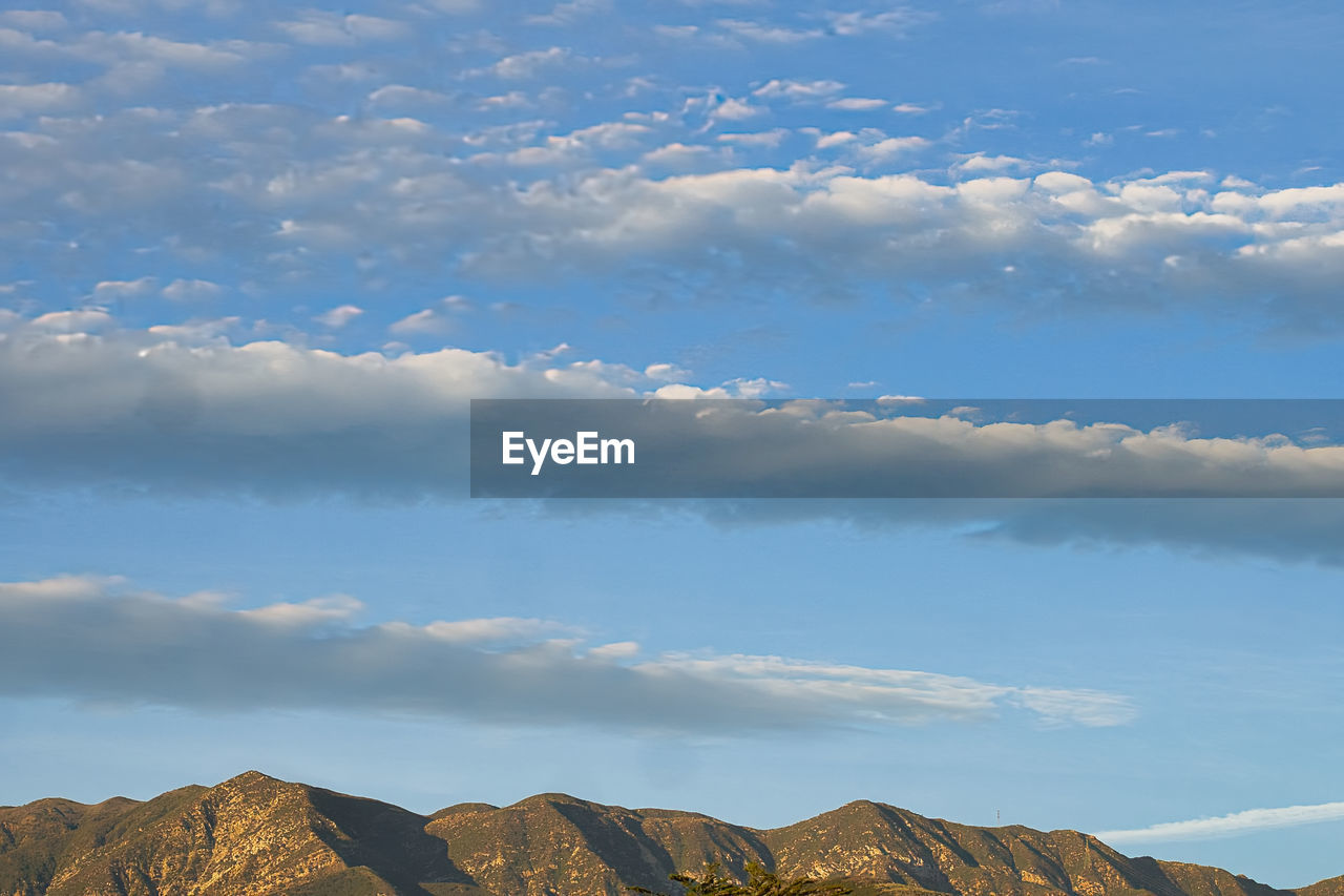 sky, cloud, environment, mountain, landscape, scenics - nature, nature, horizon, beauty in nature, mountain range, no people, travel, blue, travel destinations, land, rock, outdoors, plateau, sunlight, tranquility, day, tourism, tranquil scene, cloudscape, non-urban scene