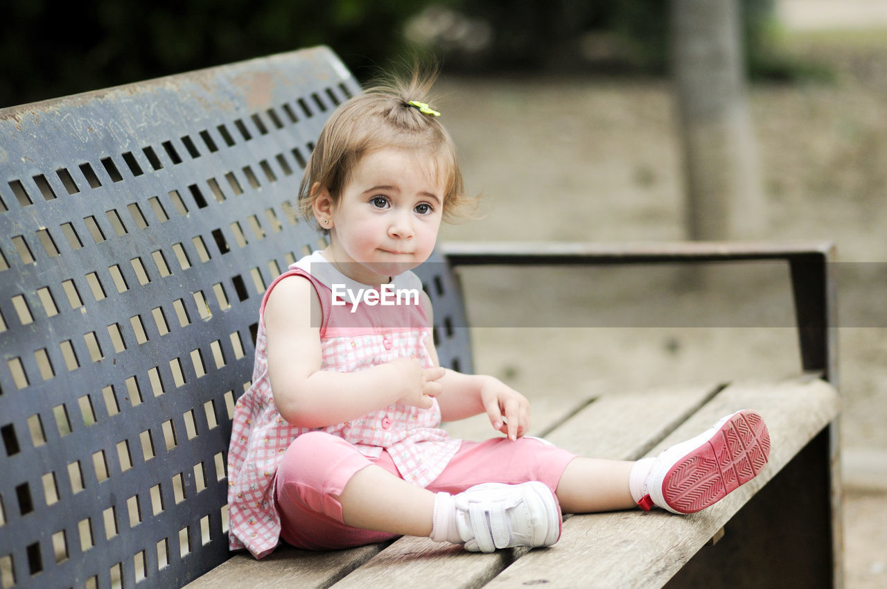 Cute girl sitting on bench 