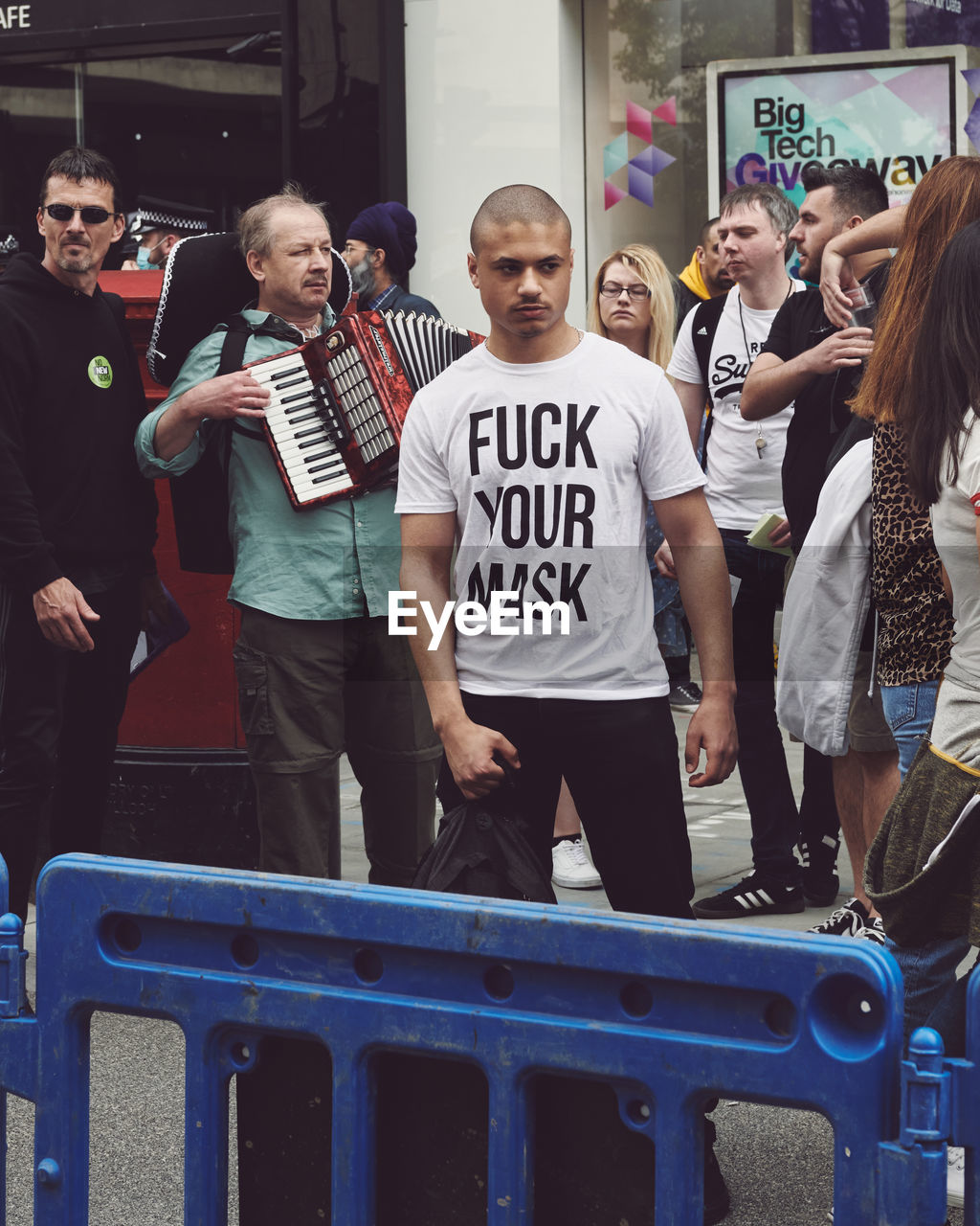 GROUP OF PEOPLE STANDING IN FRONT OF TEXT