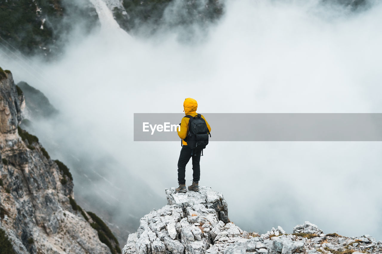 rear view of man walking on rock