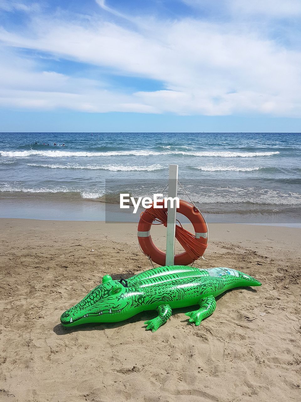 TOY ON BEACH AGAINST SKY