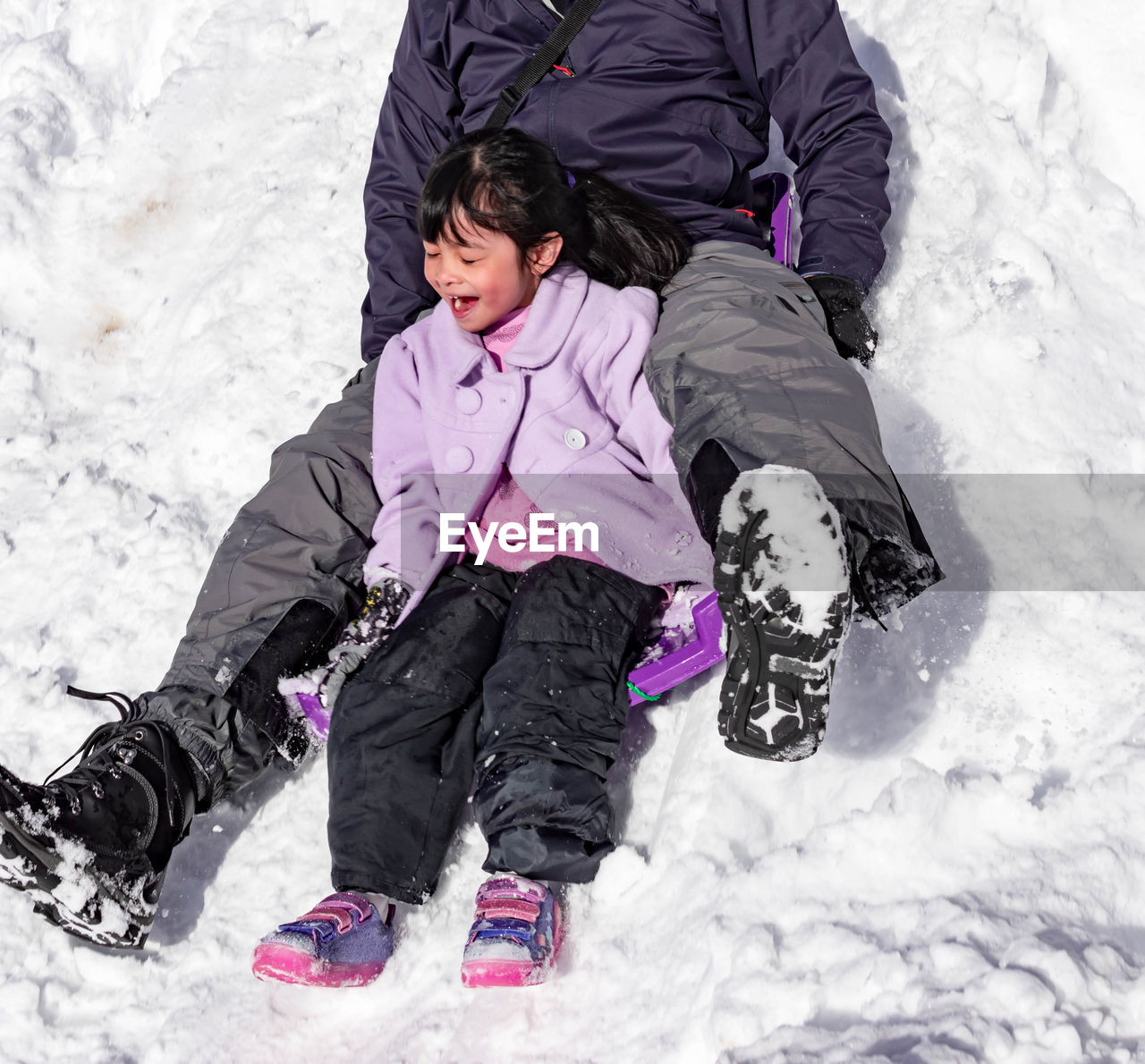 High angle view of man lying on snow