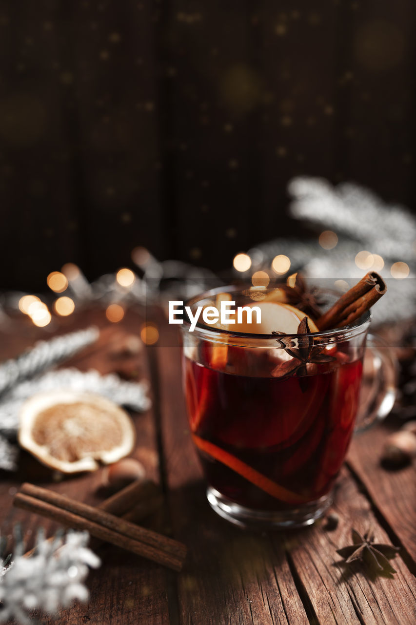 Glass cup of mulled wine on wooden table and background. christmas time concept