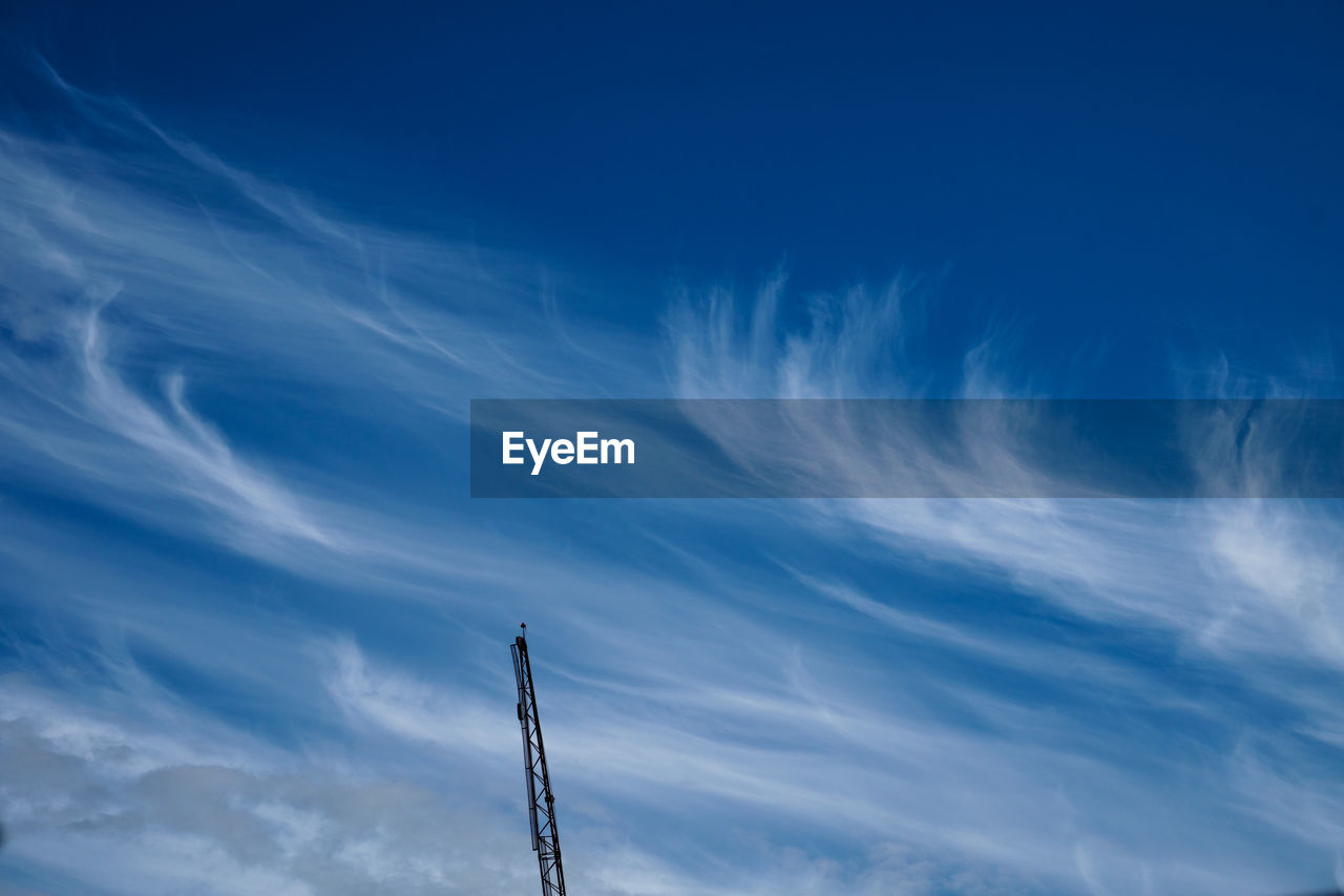 LOW ANGLE VIEW OF CABLES AGAINST BLUE SKY