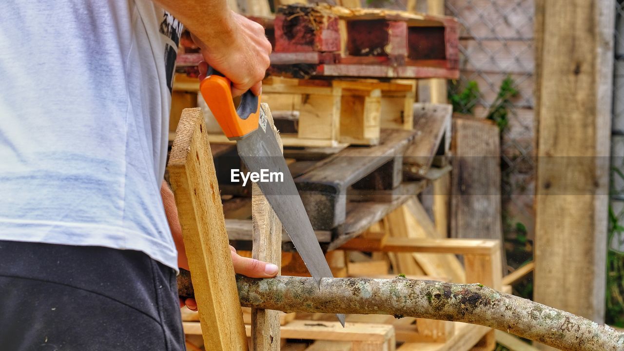 Low section of man working on wood