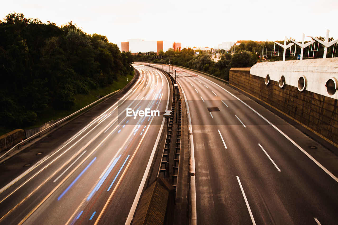 High angle view of light trails on highway against clear sky