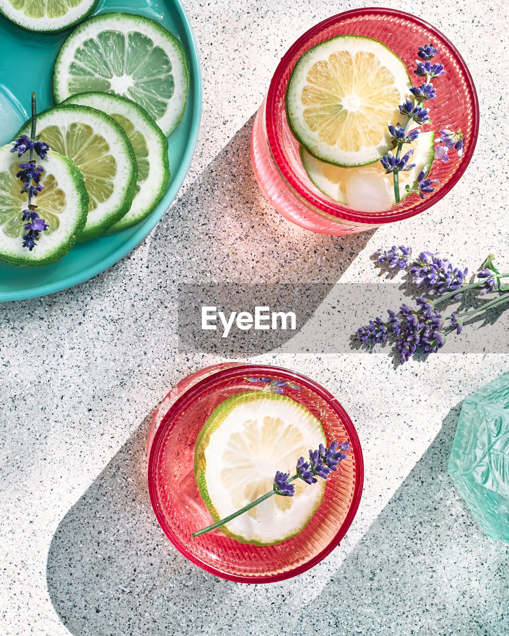 Cool lavender lemonade with lime slices and lavender flower on the table