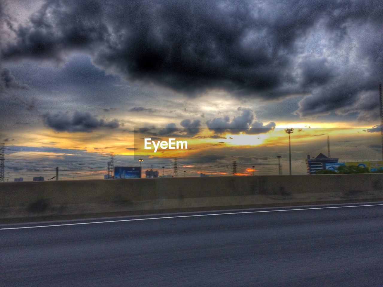 VIEW OF ROAD AGAINST CLOUDY SKY AT SUNSET