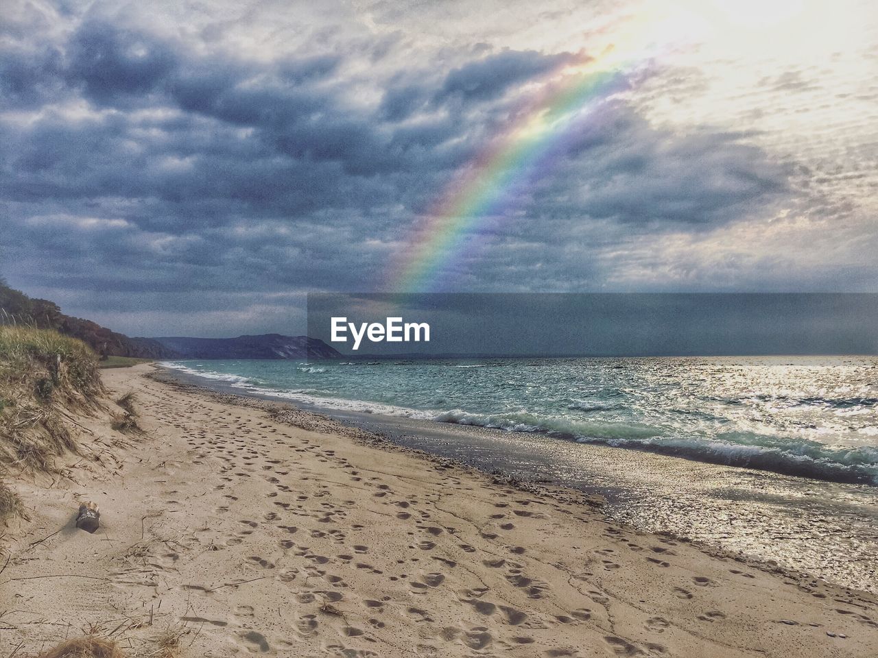 Scenic view of beach against sky during sunset