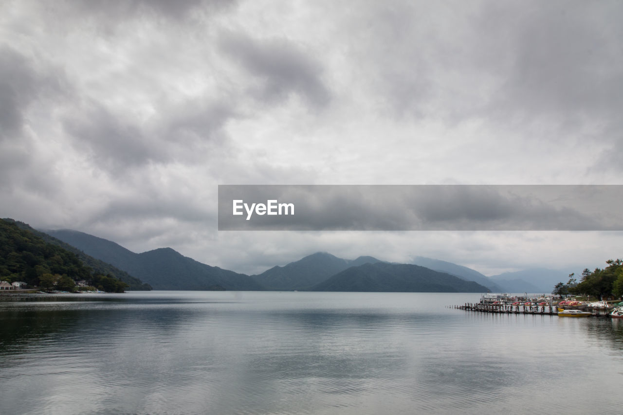 SCENIC VIEW OF MOUNTAINS AGAINST CLOUDY SKY