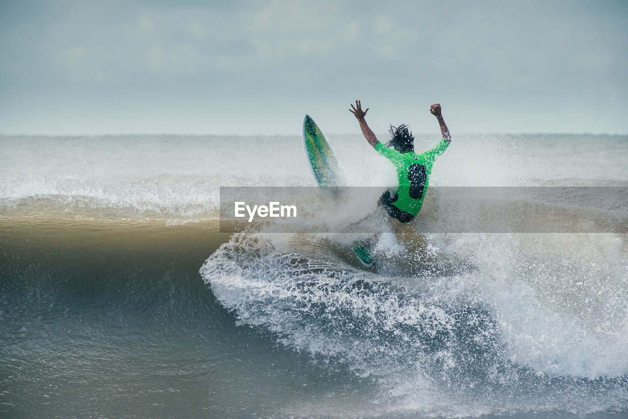 MAN SURFING ON SEA