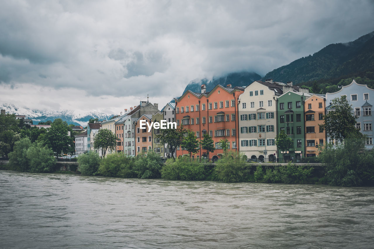 River by buildings against sky in city