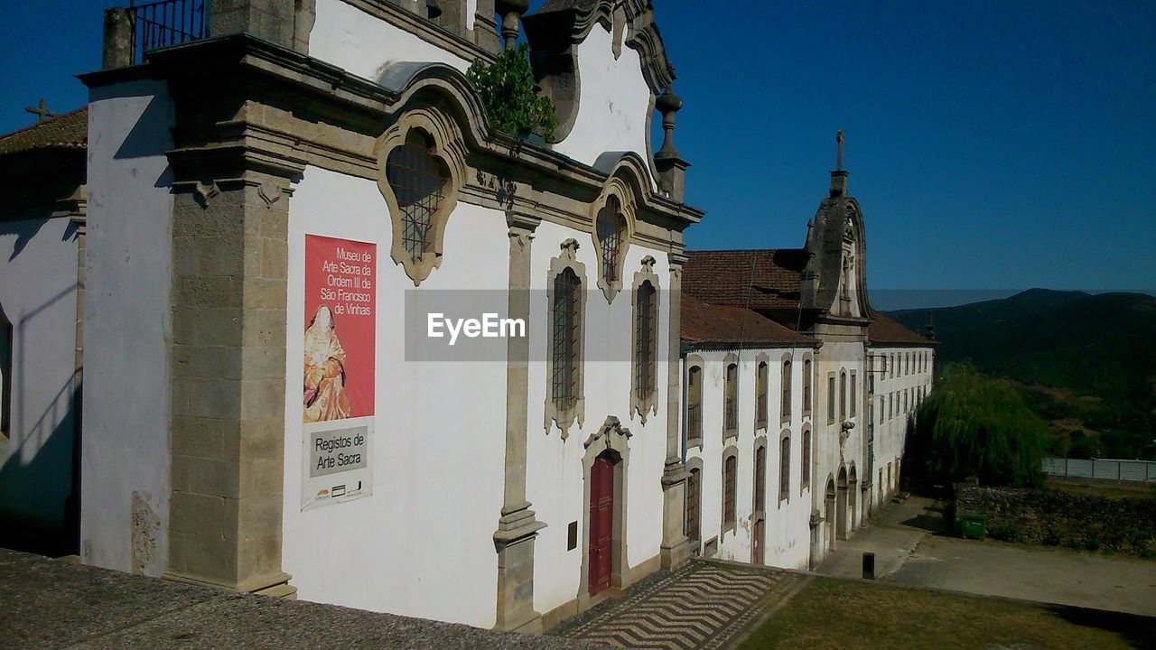 Exterior of church against clear blue sky