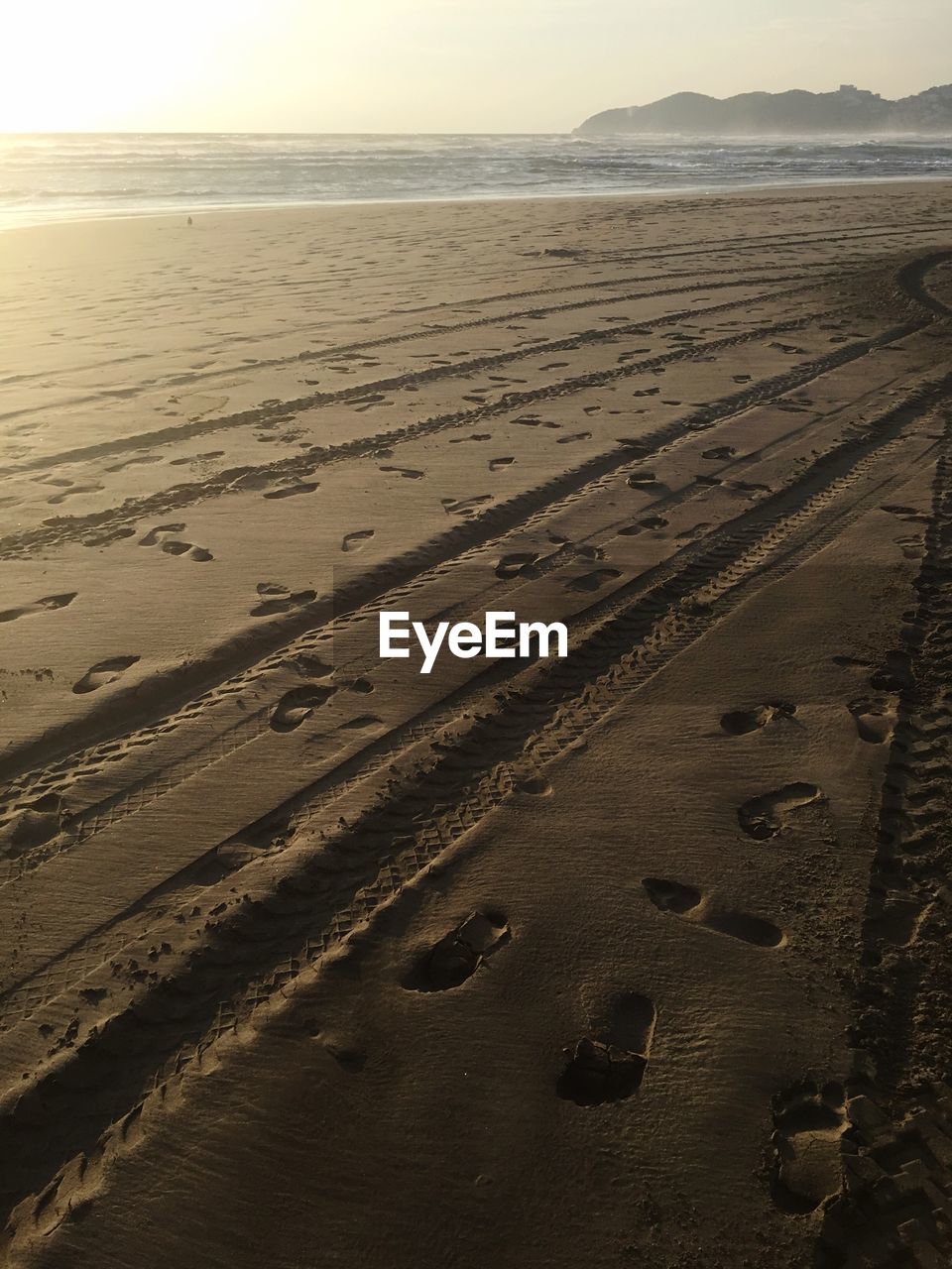 FOOTPRINTS ON SAND AT BEACH