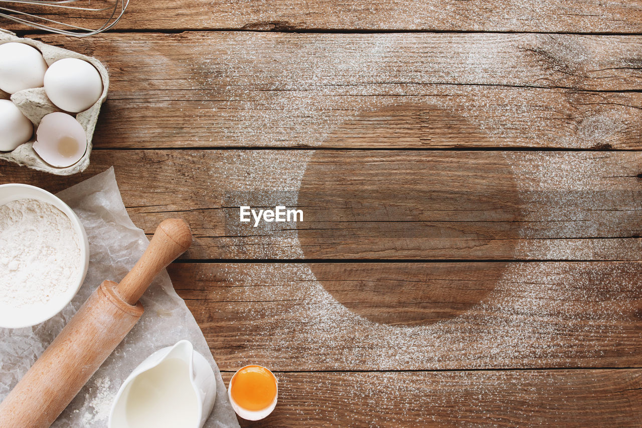 Baking ingredients, kitchen utensils on old wooden background. cooking dough