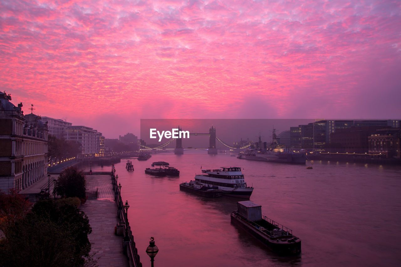 BOATS IN RIVER AT SUNSET