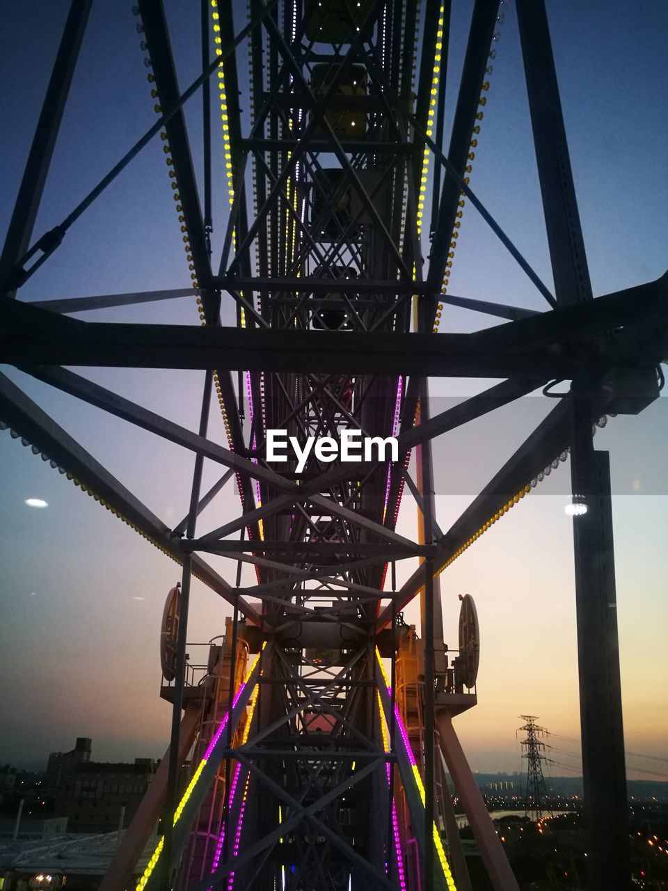 Close-up of ferris wheel in park at dusk