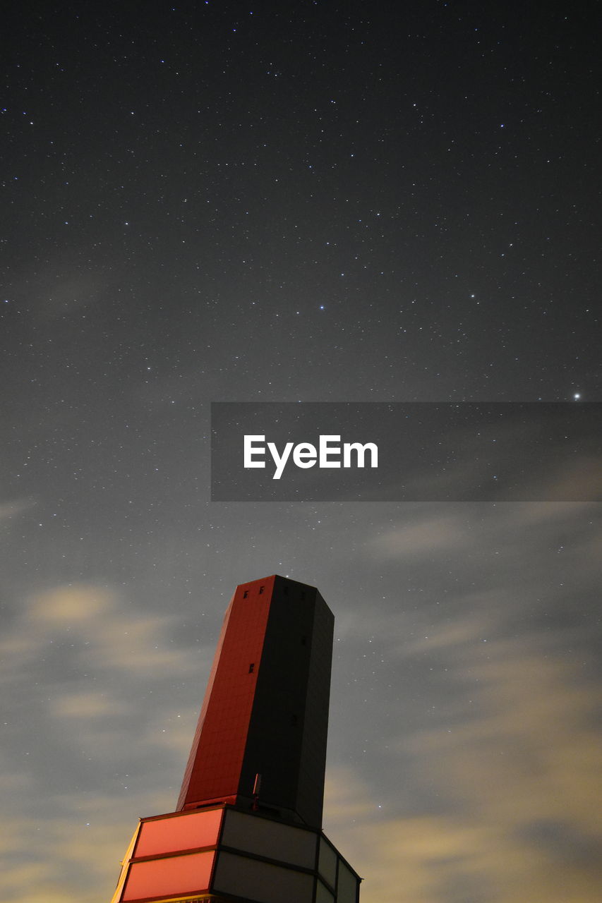 Aliens, low angle view of illuminated light against sky at night