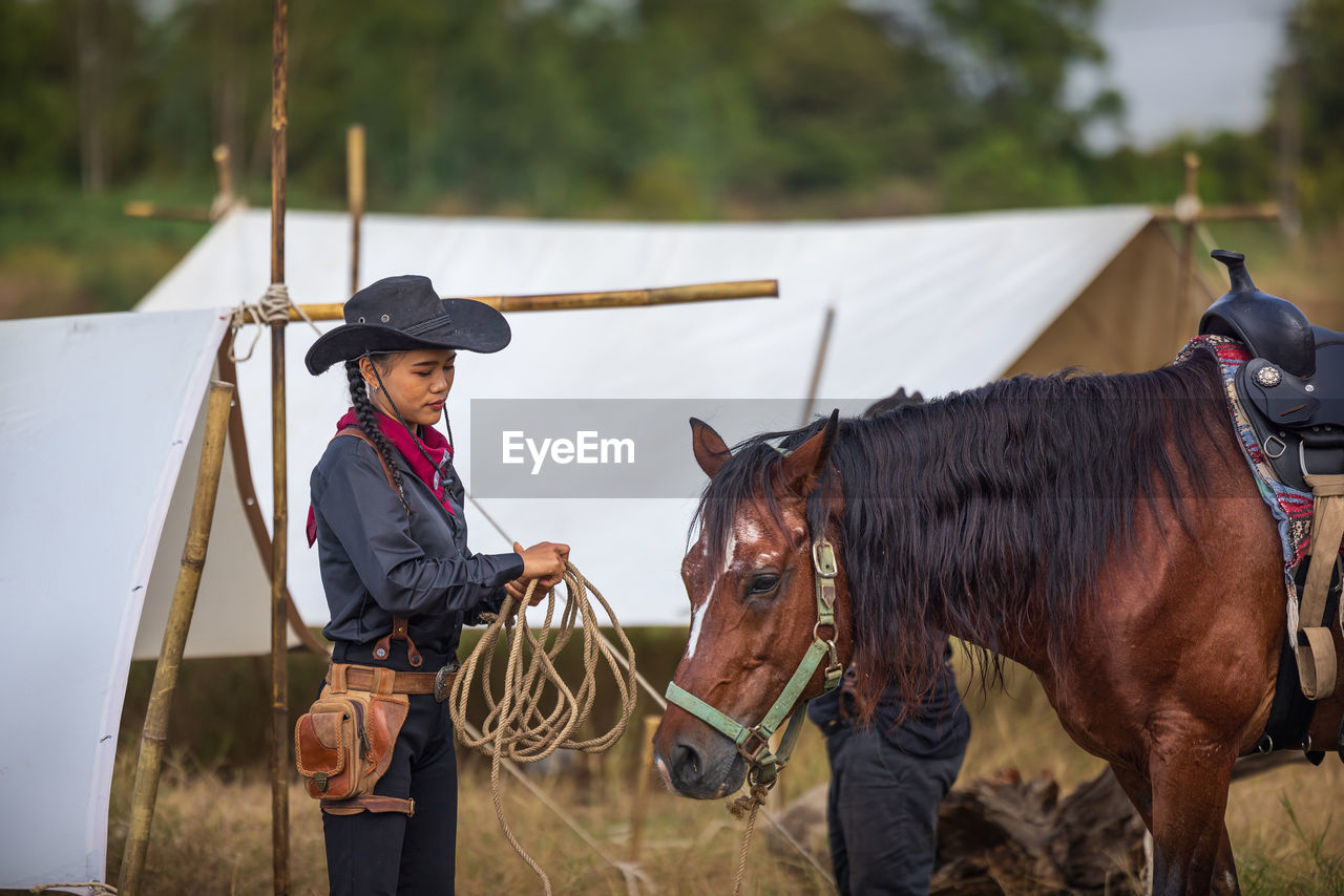 Rear view of woman riding horse