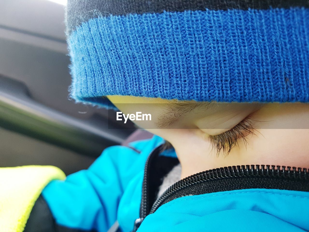 Close-up of child wearing warm clothing in car