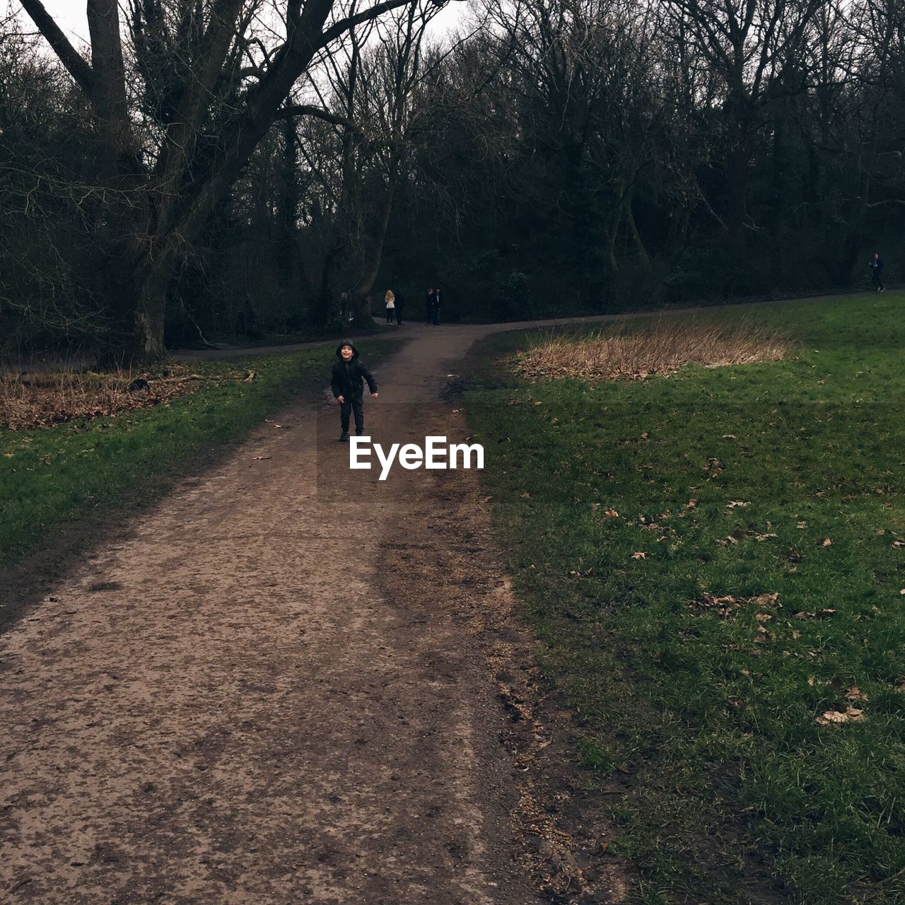 WOMAN WALKING ON FOOTPATH