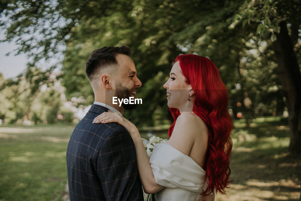 Wedding day. happy bride and groom hugging and laughing red hair diversity