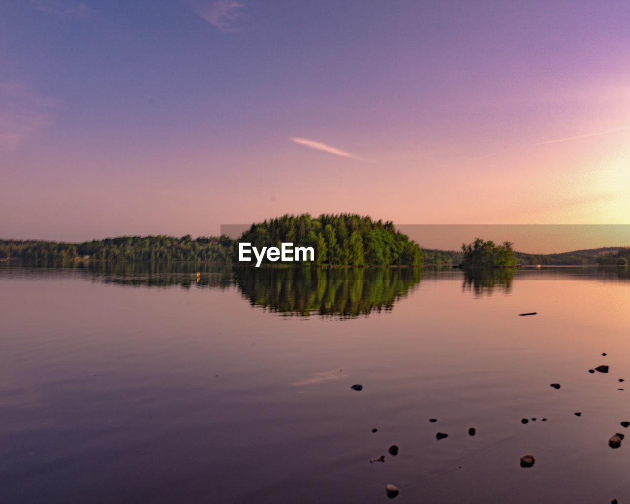 Scenic view of lake against sky during sunset