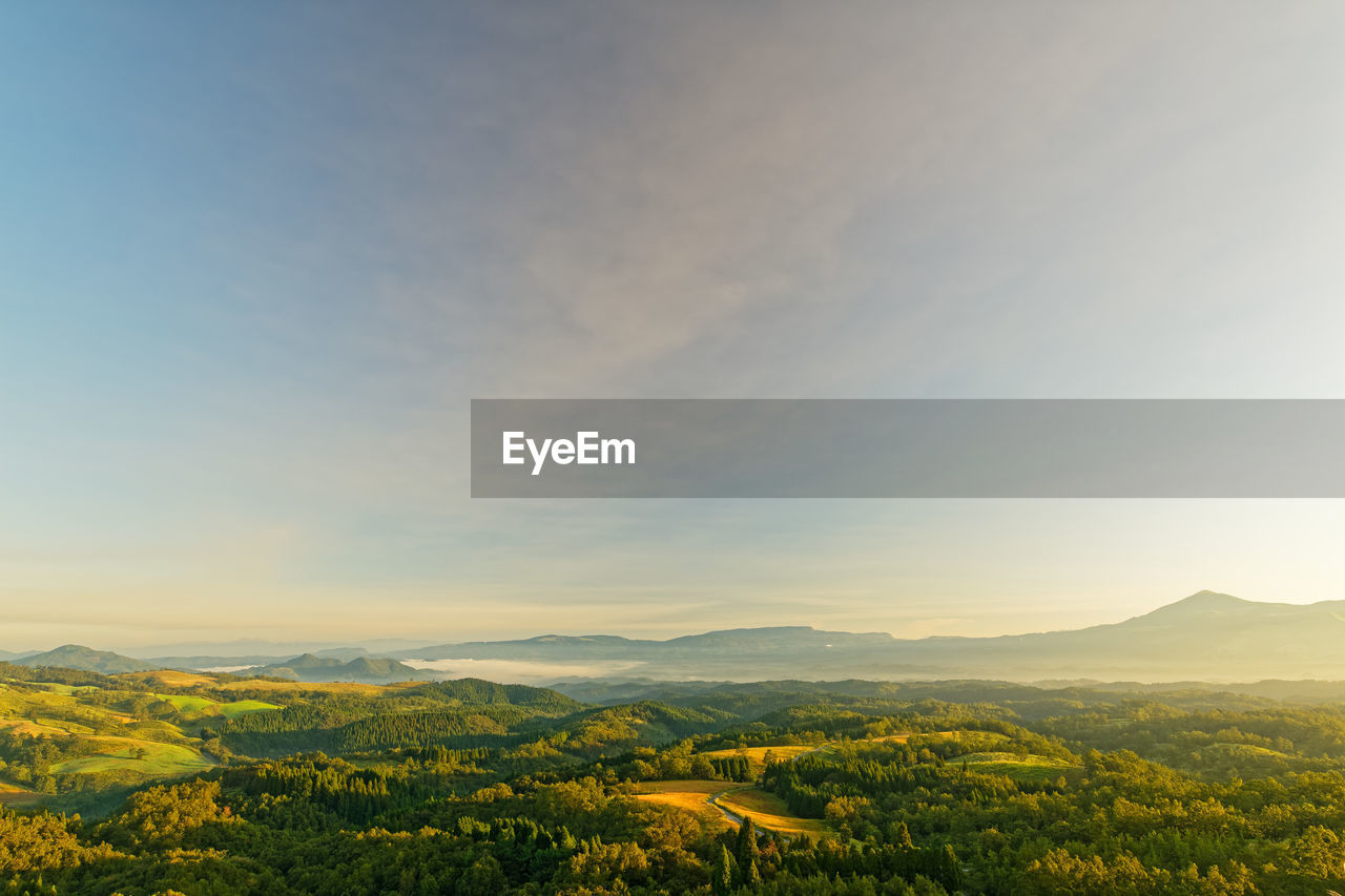 Scenic view of landscape against sky during sunrise