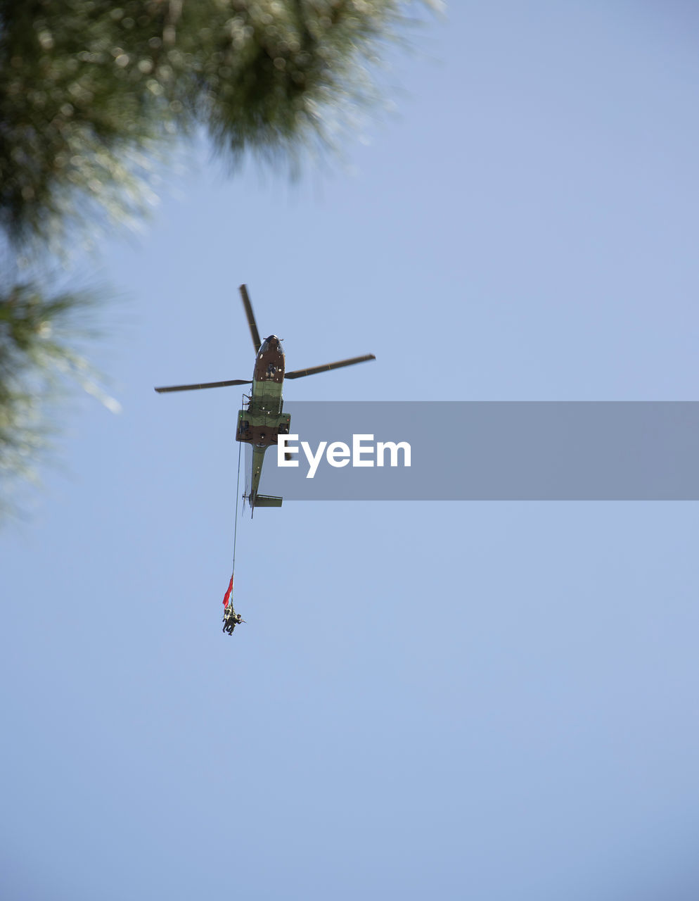 LOW ANGLE VIEW OF HELICOPTER AGAINST CLEAR SKY