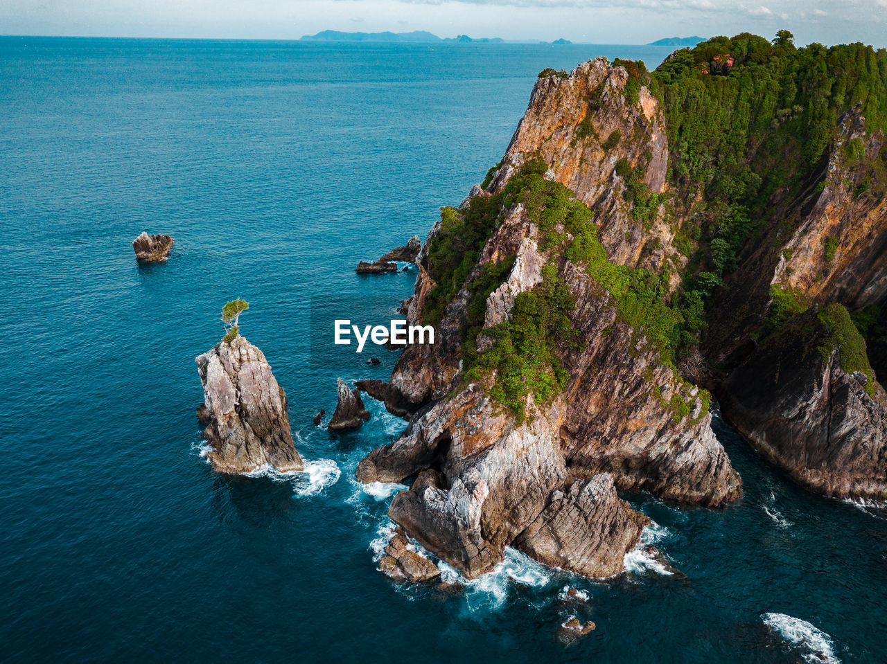High angle view of rocks in sea against sky