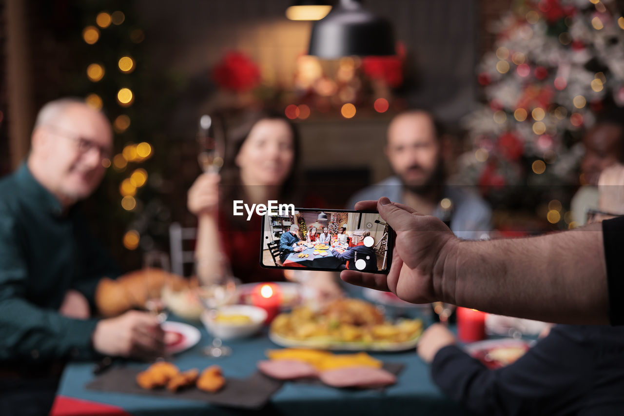 cropped hand of woman holding christmas cookies