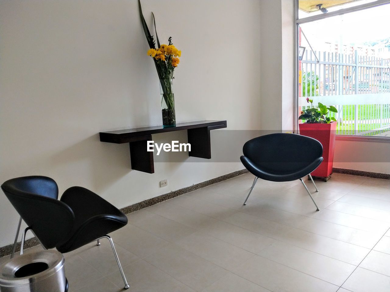 POTTED PLANT ON TABLE BY CHAIR