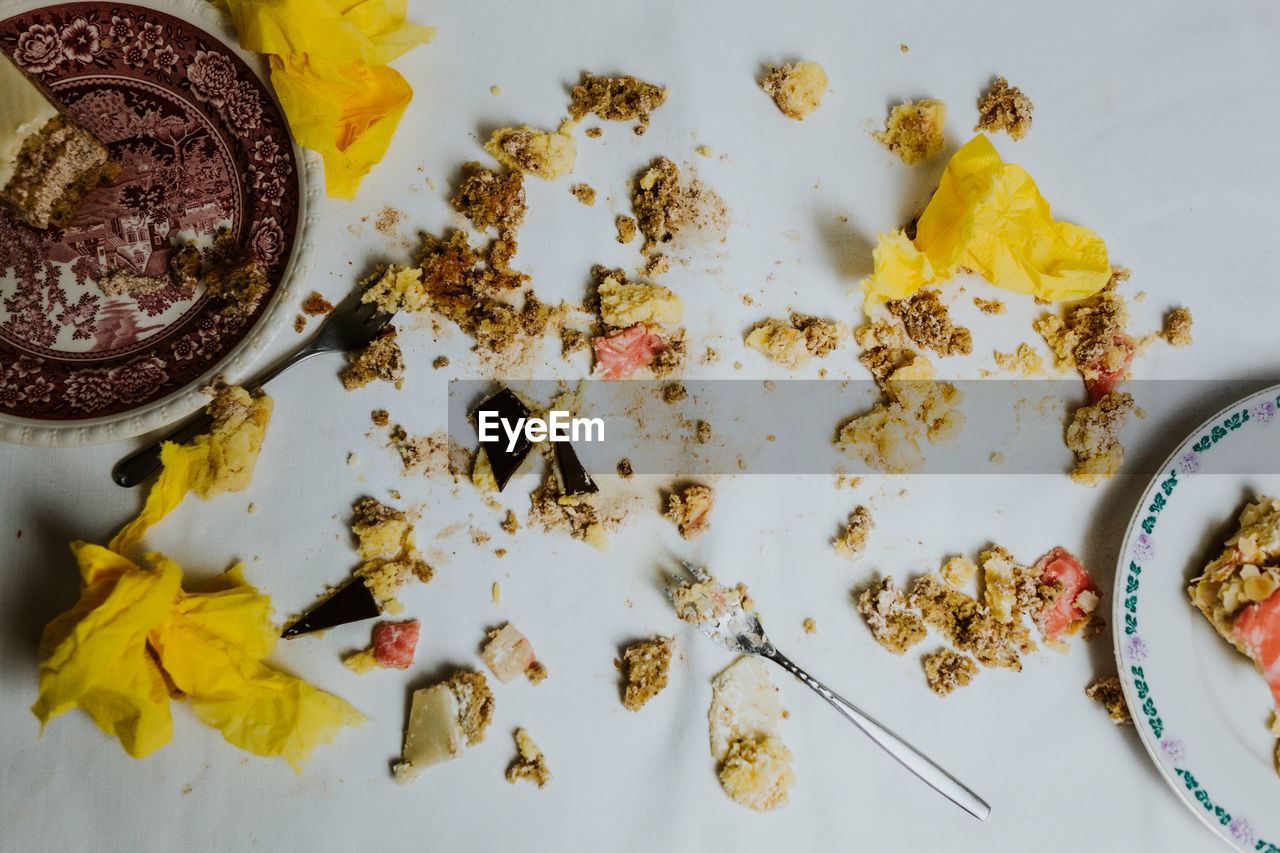 High angle view of food on table - toy soldiers fight in between pieces of cakes