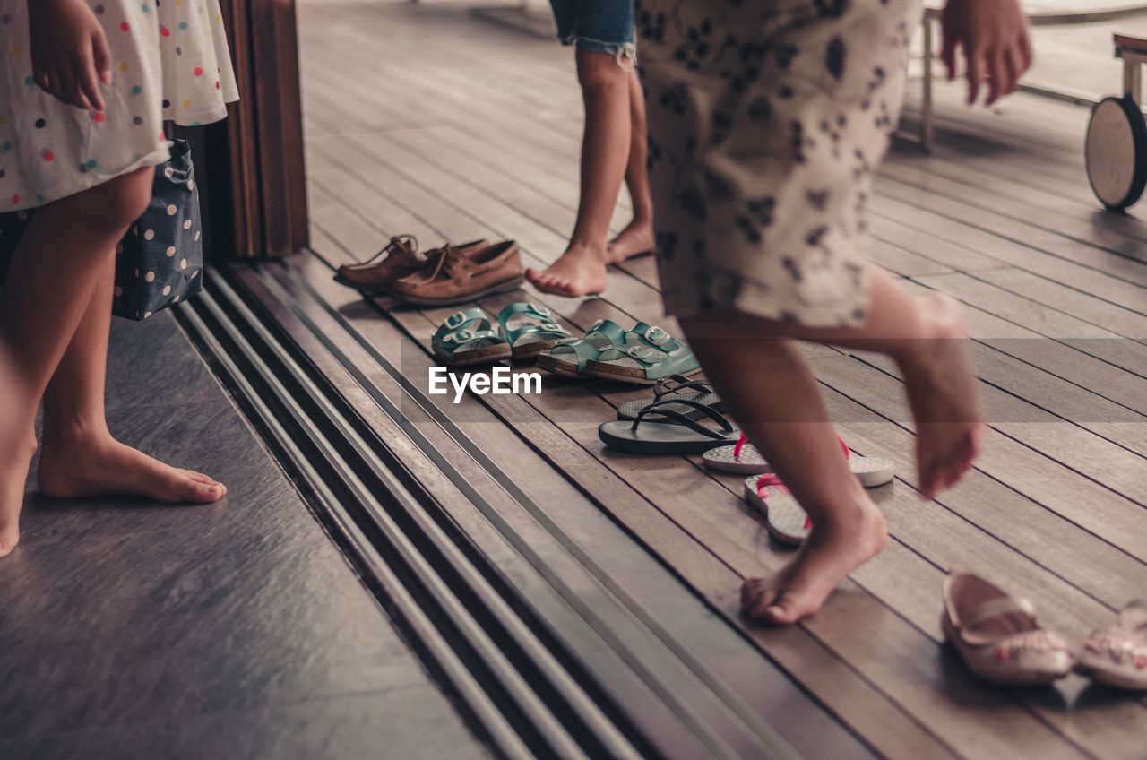 Low section of people on wooden floor