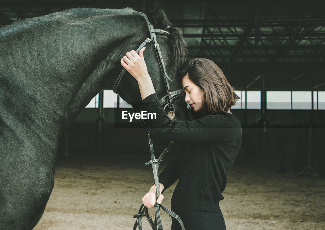 Woman standing with horse