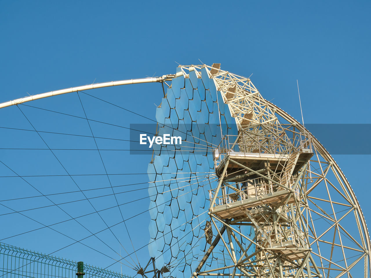 Magic telescope with mirror segments against cloudless blue sky in daylight at astronomical observatory site on island of la palma in spain